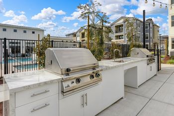 Outdoor BBQ area with 2 Grills and Apartment Exteriors